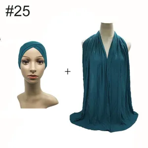 Modal elastic under-cap and oversized scarf detail view in dark green, perfect matching set.
