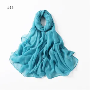 Blue glitter detail of the lightweight cotton linen scarf showing soft shimmering texture.