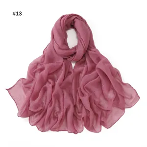 Detail shot of the shimmering dusty pink starry voile scarf, showing lightweight texture.