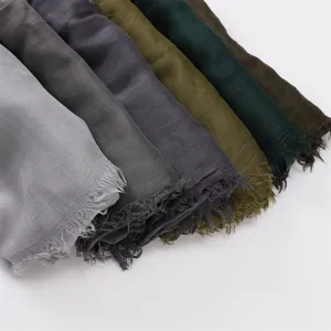 Detailed view of assorted solid color soft modal cotton fringe scarves in multiple shades.