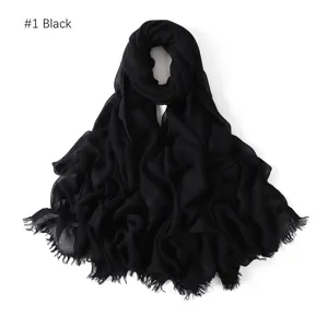 Close-up detail of a lightweight black modal cotton scarf with delicate fringed edges.