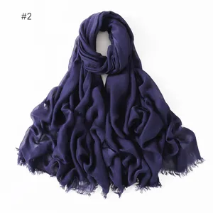 Detail of solid color modal scarf fringe texture, breathable lightweight fabric design.