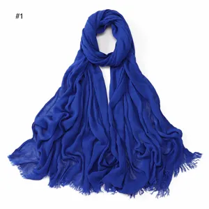Solid color crinkled rayon scarf for women, lightweight breathable hijab with frayed tassel ends.