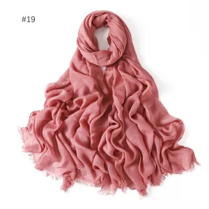 Detail view of the soft modal solid color scarf showing delicate short fringe edges and texture.