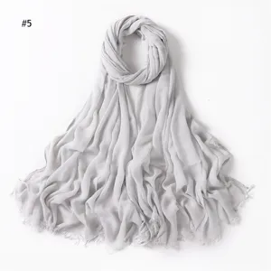 Solid color gray rayon crinkled scarf with tassels, breathable, soft, elegant hijab accessory.