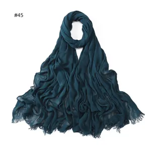 Dark blue crinkled modal scarf for women, soft breathable solid color hijab with frayed ends.