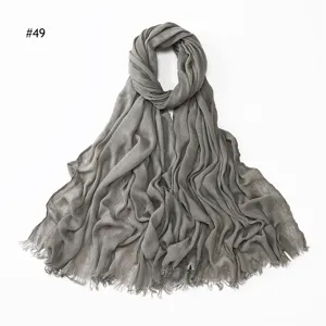 Solid color crinkled rayon scarf with fringe detail, breathable and soft hijab accessory.