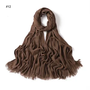 Solid color crinkled rayon scarf for women, soft breathable fabric with frayed tassel ends.