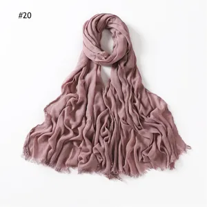 Dusty pink rayon crinkle scarf with frayed fringe edges, soft and breathable modal hijab.