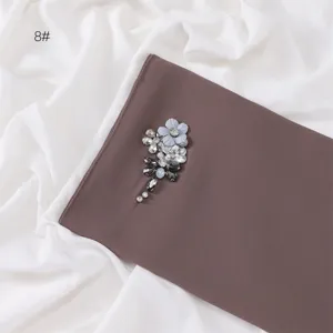Detailed close-up shot of chiffon hijab with handcrafted rhinestones and delicate floral decor.