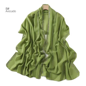 Detailed view of avocado green chiffon scarf featuring sparkling rhinestone trim.