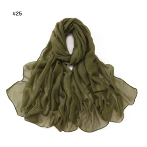 Olive green starry voile scarf detail, lightweight sheer fabric with shimmering gold dots.