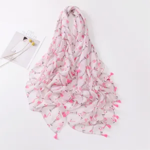 Detailed view of the soft pink flamingo print scarf featuring delicate handmade tassels.
