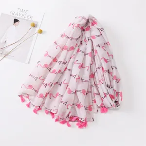 Pink flamingo printed scarf detail featuring delicate handmade tassels and soft fabric.