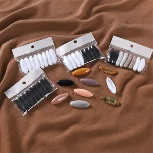Close-up view of colorful plastic hijab pins and safety scarf buckles in transparent bags.