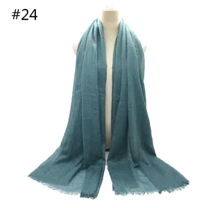 Detailed view of the teal cotton linen scarf, featuring soft breathable fabric and short fringe.