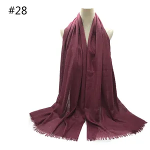Solid color dark red tassel scarf, breathable cotton blend winter fashion accessory.