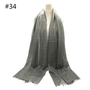 Grey solid color lightweight breathable cotton blend scarf with fringe detail for women.