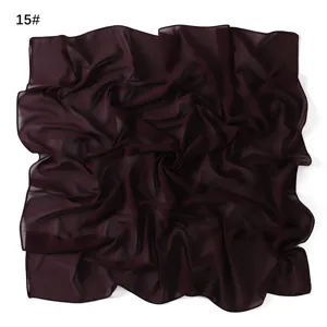Detail view of dark red chiffon square scarf, lightweight breathable fabric texture.