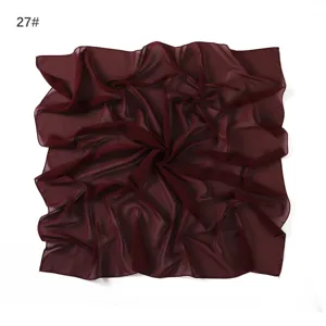 Detail shot of the lightweight wine red chiffon square scarf showing delicate fabric texture and drape.
