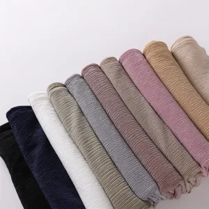Detailed view of multi-color solid pleated hijabs, soft and breathable fabric rolls.