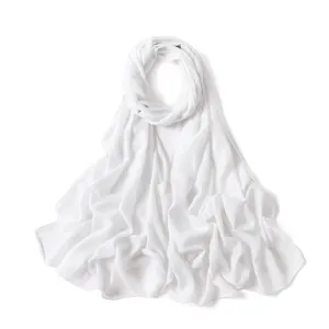 Sparkly white chiffon scarf detail showing shiny silver glitter texture and elegant fabric drape.
