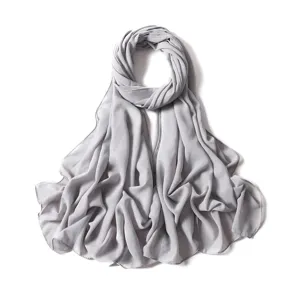 Close-up detail of the shimmering grey chiffon hijab fabric showing delicate silver glitter.