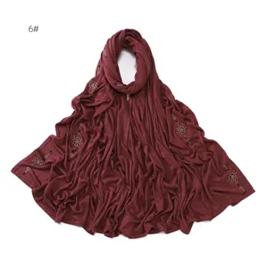 Detailed view of the burgundy rhinestone embellished jersey hijab scarf, soft stretch fabric.