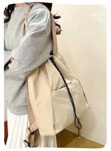 Detailed view of the casual beige canvas backpack in daily use, featuring secure drawstring.