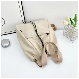 Minimalist beige multi-functional backpack stylish casual drawstring bucket bag for women.