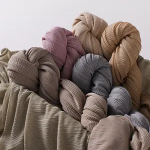 Detailed view of soft pleated jersey hijab scarves in various solid colors for daily wear.