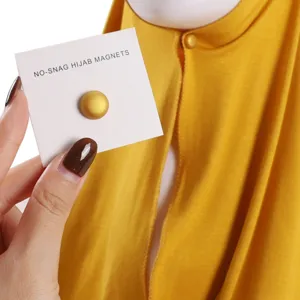 Gold magnetic hijab pin close-up detail showcasing the matte finish button and card packaging.