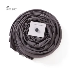 Detailed view of the dark grey mercerized cotton hijab scarf with a magnetic pin card.
