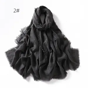 Dark grey crinkled linen gauze scarf with frayed tassel edges, breathable solid color shawl wrap.