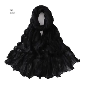Close-up detail of a black crinkled thin breathable scarf, showcasing the fine texture.