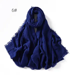 Detailed view of solid color cotton linen scarf, breathable gauze shawl fringe wrap.