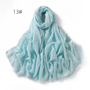 Light blue solid color linen breathable gauze scarf shawl detail, featuring elegant fringe.