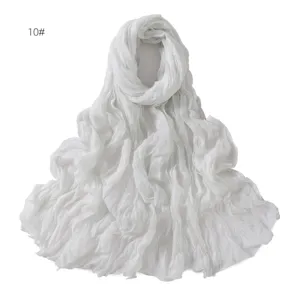 Detailed view of the white crinkled lightweight scarf, featuring soft breathable fabric.