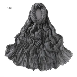 Detail view of the dark grey crinkled lightweight scarf, breathable cotton linen fabric texture.