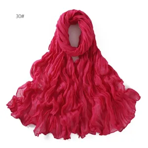 Close-up view of the crinkled magenta voile scarf fabric texture and delicate edge details.