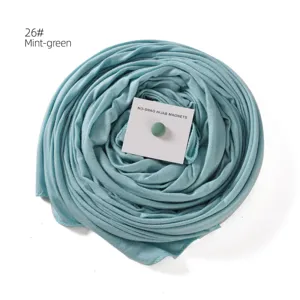 Mint green hijab scarf with magnetic pin detail, elegant daily headwrap accessory.