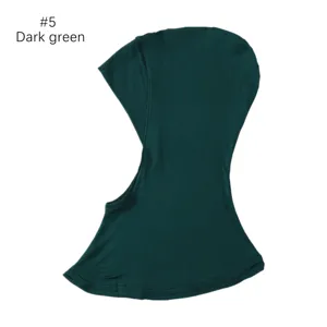 Modal hijab under cap, dark green elastic scarf cap detail shot showing fine fabric texture.
