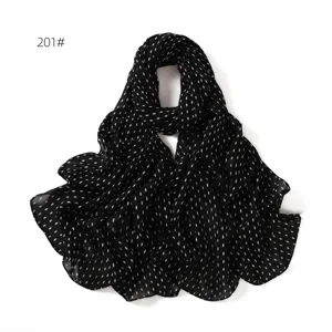 Close-up view of black chiffon scarf with delicate white diamond dot patterns and soft texture.