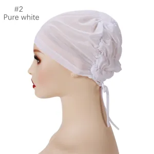 Detailed view of the breathable mesh inner cap with adjustable tie strings in pure white.