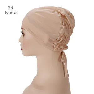 Detailed view of breathable mesh inner cap, elastic adjustable turban with ties in nude color.
