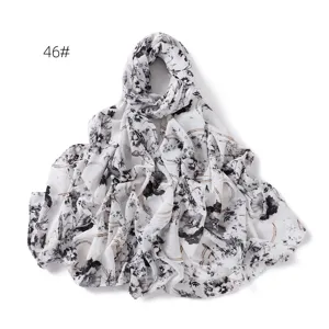 Detailed view of the black and white floral chiffon scarf, lightweight sun protection wrap.