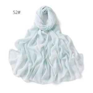 Detailed view of light blue chiffon scarf fabric, showing soft draping and fresh print pattern.