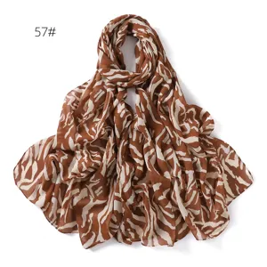 Detailed view of the stylish brown printed chiffon scarf, lightweight and elegant accessory.