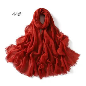 Detailed view of the solid color crinkled cotton linen breathable fringe scarf shawl.