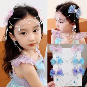 Bonitas horquillas de sirena para niños con borla de perlas y un lazo brillante.